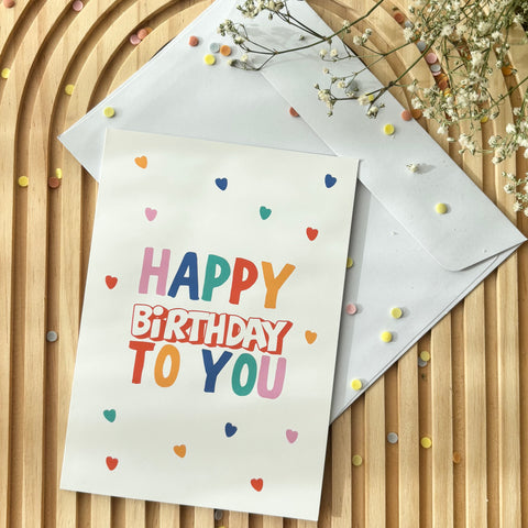 Carte d'anniversaire « Happy Birthday » colorée avec de nombreux cœurs