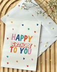 Biglietto di auguri di compleanno "Happy Birthday" colorato con tanti cuori